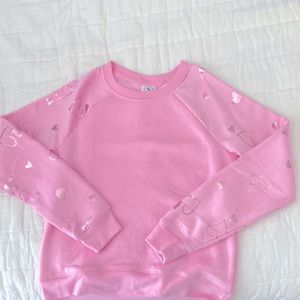 pink shirt with hearts on sleeves